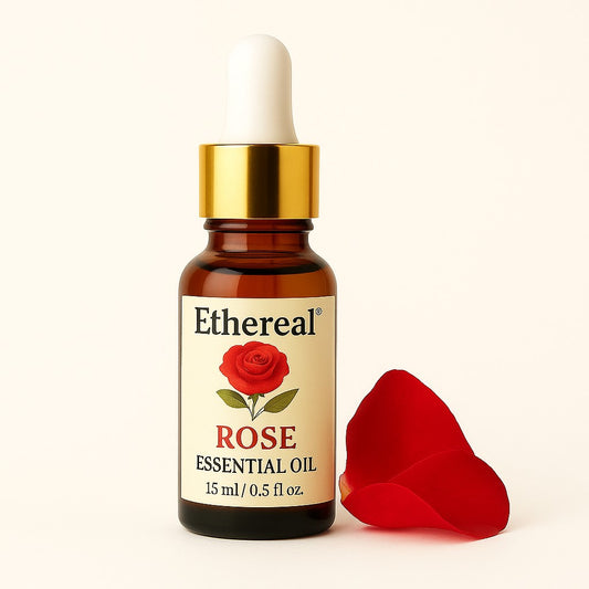 Ethereal Rose Bulgarian Essential Oil 15ml amber glass bottle with gold dropper, centered on soft cream background with rose petals on the right side